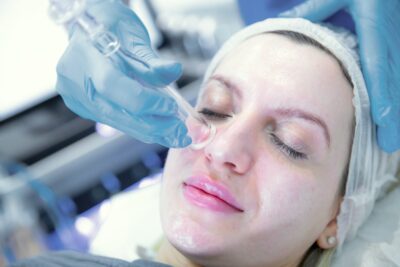HydraFacial handpiece used on the face during treatment