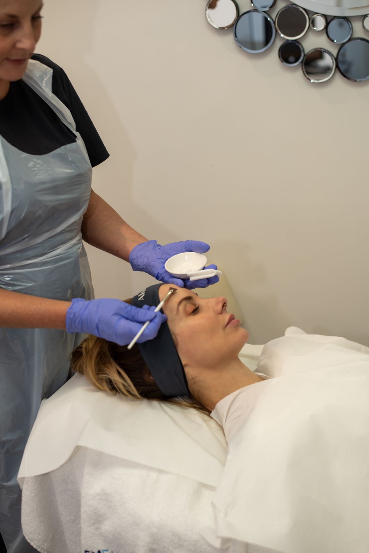 Practitioner preparing to apply a chemical peel at Regents Park Aesthetics