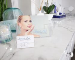 Clinic brochure and skincare products on a treatment room counter