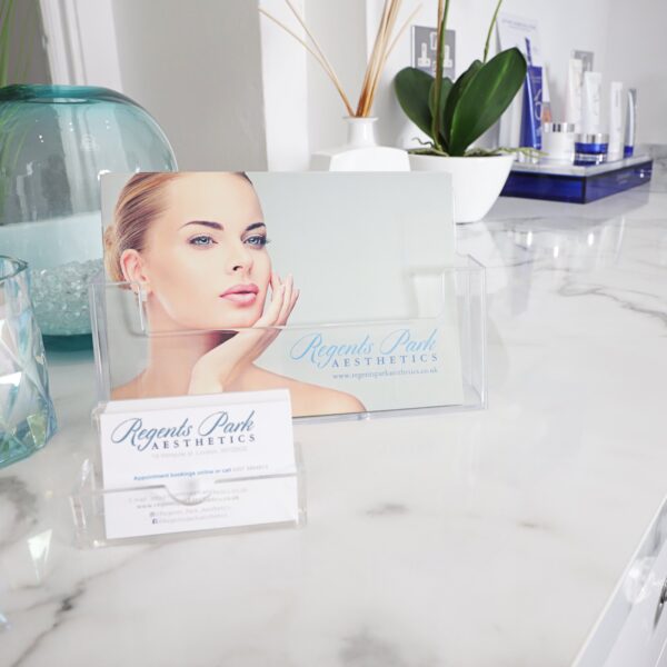Clinic brochure and skincare products on a treatment room counter